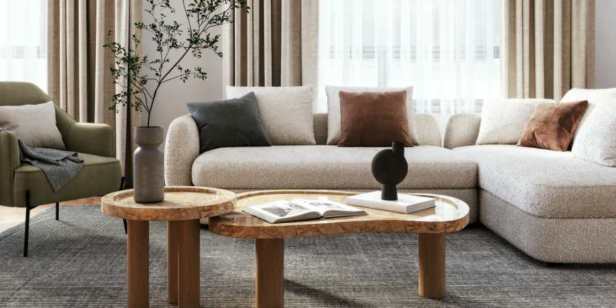 Beautifully furnished living room with bright windows in a townhome at Parkwood Oaks in Bedford, Texas