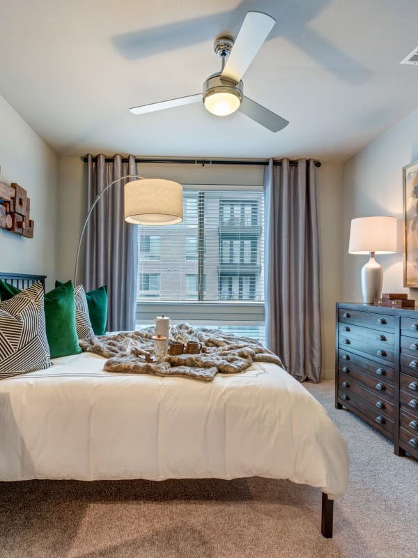 Master bedroom with a ceiling fan at Berkshire Auburn in Dallas, Texas