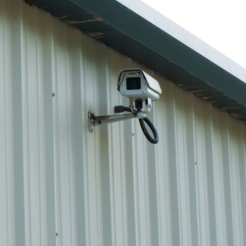 Security camera mounted on an outside wall at Red Dot Storage in Columbia, Tennessee