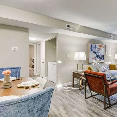 A dining room and living room in an apartment at The Point at Beaufont in Richmond, Virginia