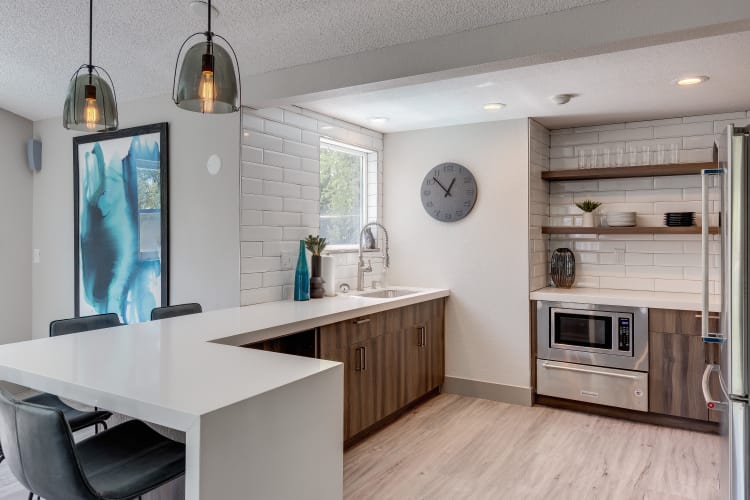 Lovely model kitchen with quartz countertops at Alaire Apartments in Renton, Washington