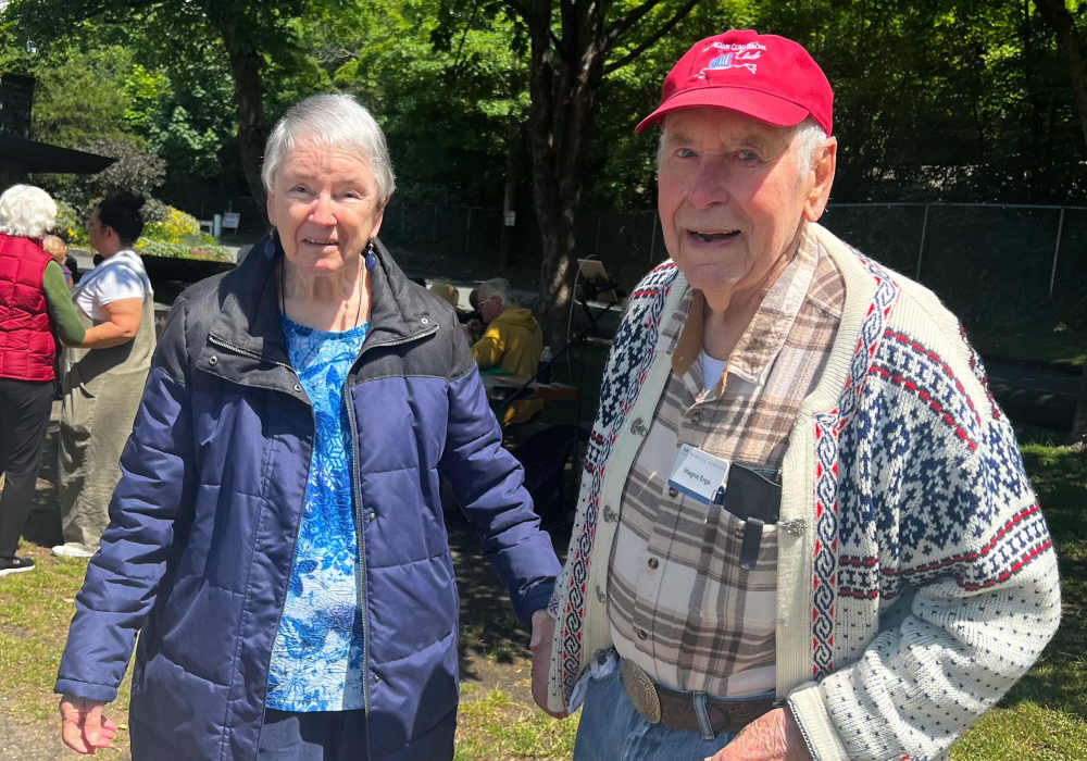 Resident couple posing outside at Merrill Gardens at Tacoma in Tacoma, Washington
