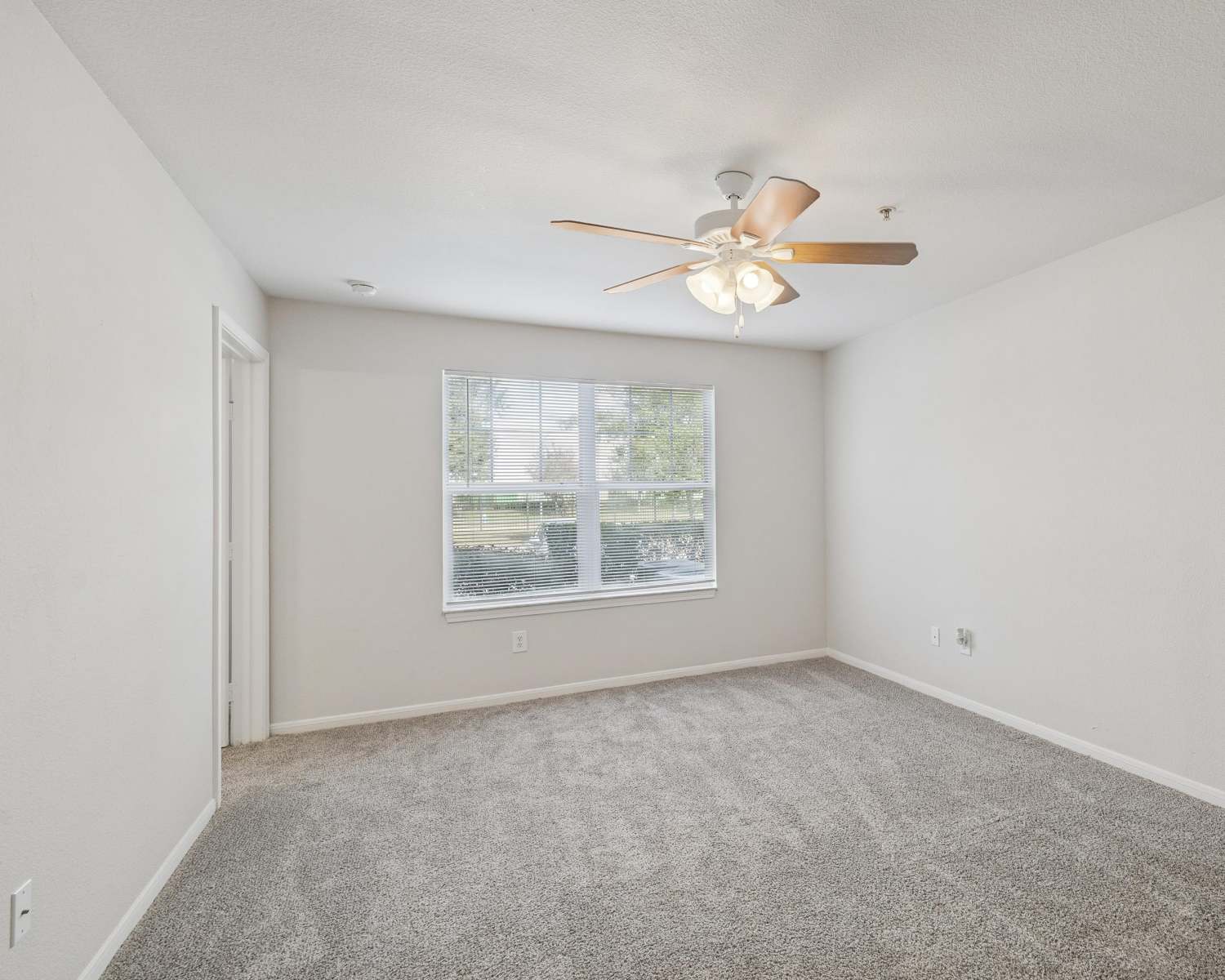 A living room with carpet flooring at Kimberly Pointe in Houston,Texas