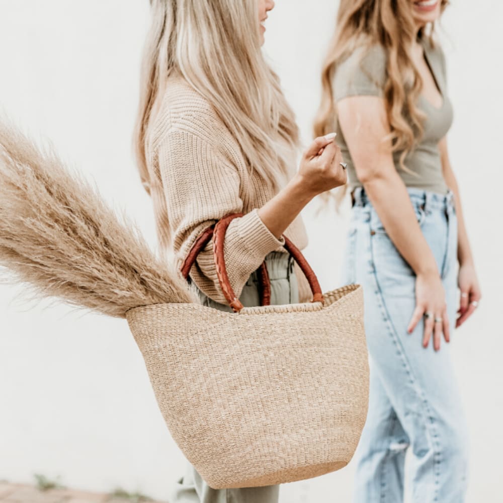 Lady friends doing some shopping downtown near Oaks 5th Street Crossing At City Center in Garland, Texas