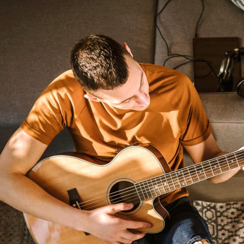 Resident playin the guitar at Mission Apartments in San Diego, California