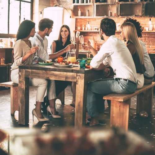 Happy friends at restaurant near The Marke Apartment Homes in Santa Ana, California
