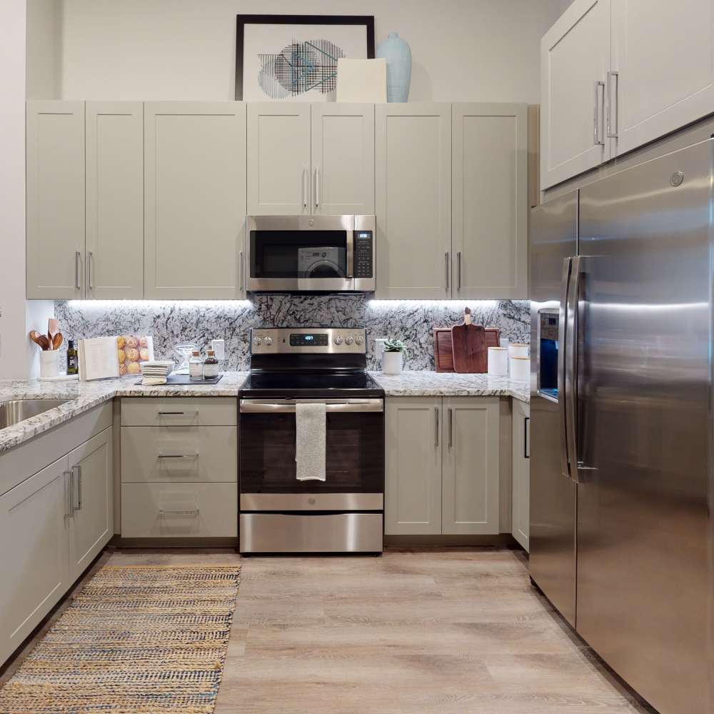 Cozy kitchen with refrigerator, range and dishwasher at Cornell Midtown in Dallas, Texas