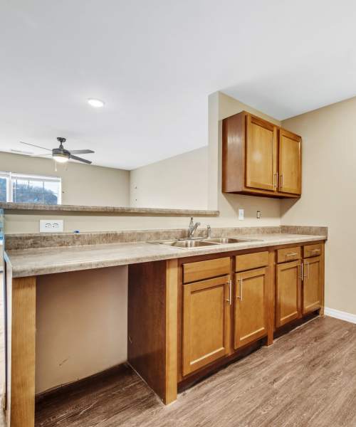 Open-concept layout connecting the kitchen area to a living room at Hobbs Greene in Wheeling, West Virginia
