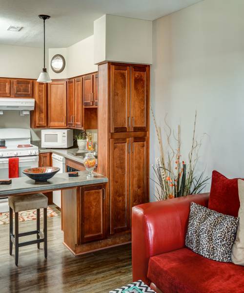 Living room with an open kitchen and a breakfast counter at The Banks At Berkley in Norfolk, Virginia