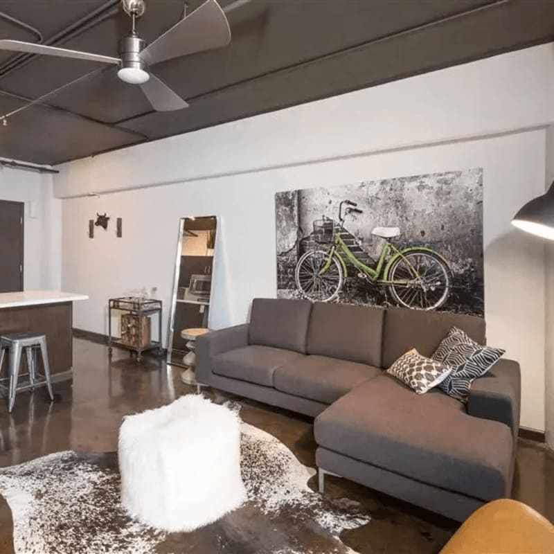 Living room with modern furniture and plank flooring at Square One in Sparks, Nevada