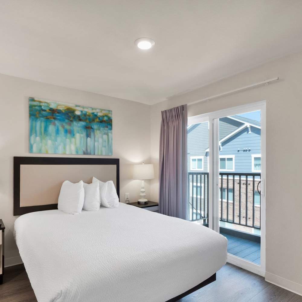 Natural lighting bedroom with large windows at WaterWalk Charlotte - Arrowood in Charlotte, North Carolina