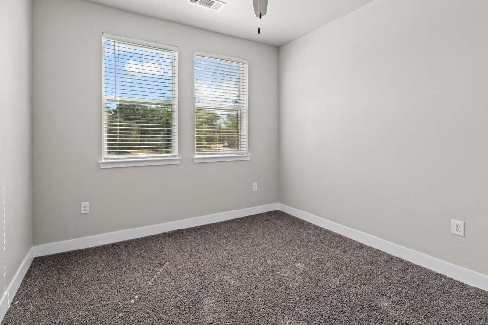 Well-lit bedroom at Pebble Brook Apartments in Jacksonville, Texas