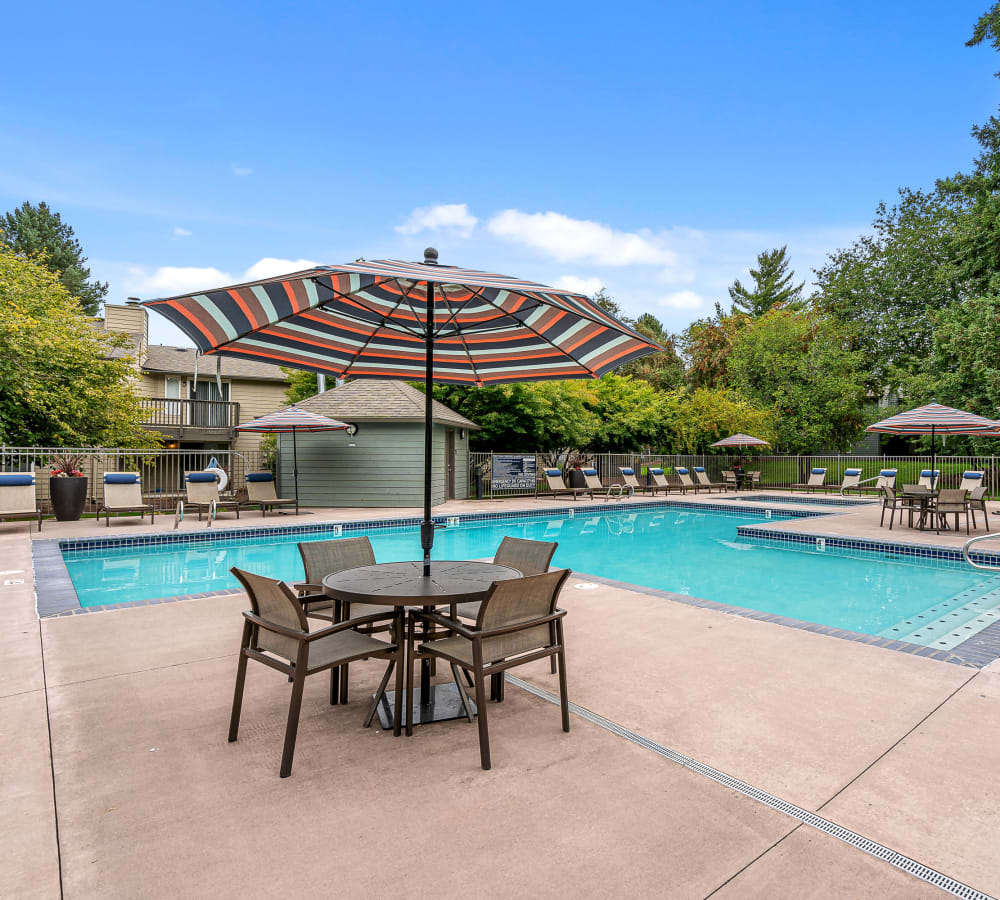 Swimming pool with lounge chairs on the deck at Terra at Hazel Dell in Vancouver, Washington