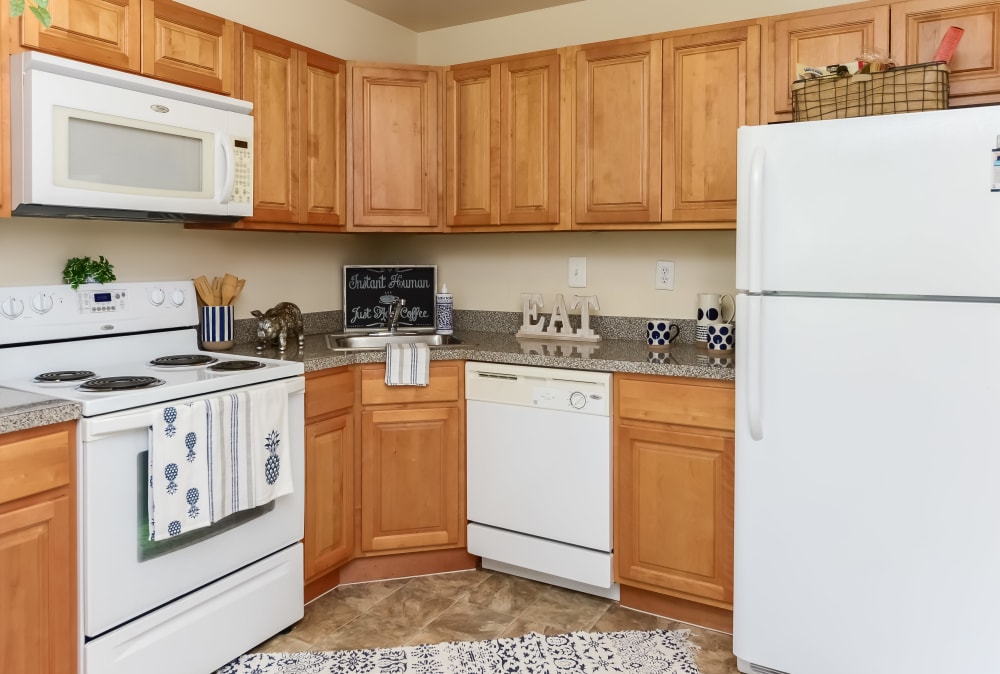 Kitchen with white appliances at Sherwood Village Apartment & Townhomes in Eastampton, New Jersey