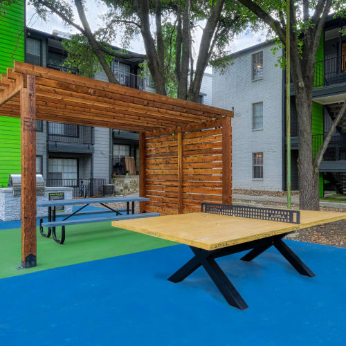 Picnic tables in the outdoor area at The Sage at 1955 in San Antonio, Texas