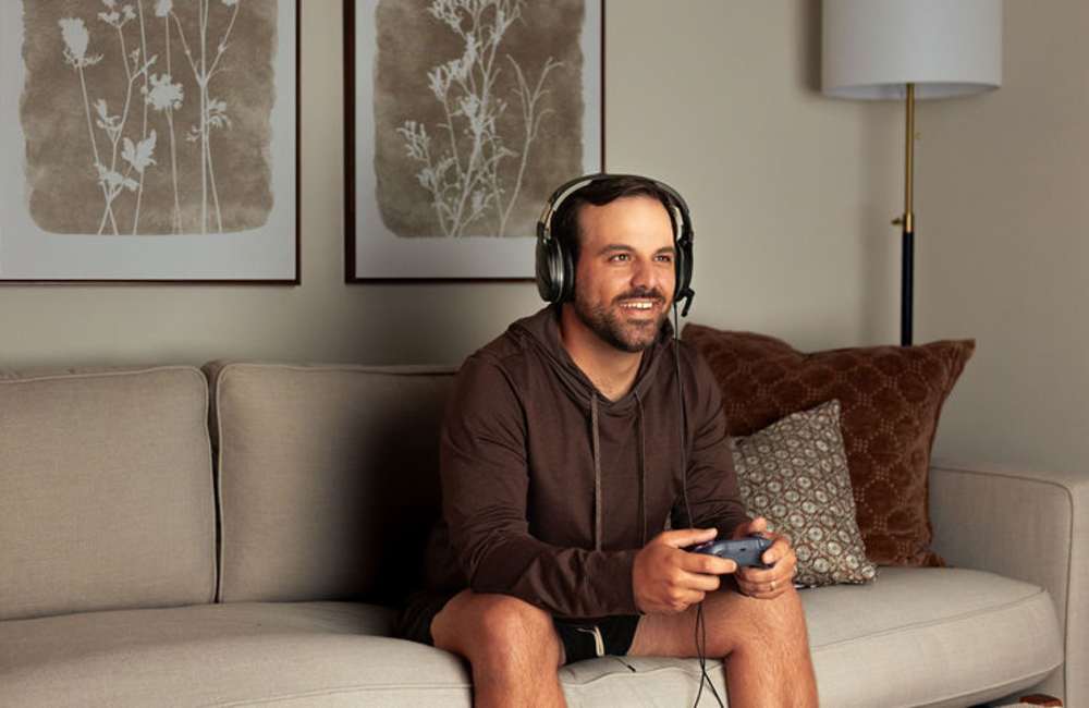 Resident playing games in an apartment at The Waters at Promenade in Marrero, Louisiana