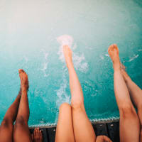 Friends using the pool at The Ardent in Mill Creek, Washington