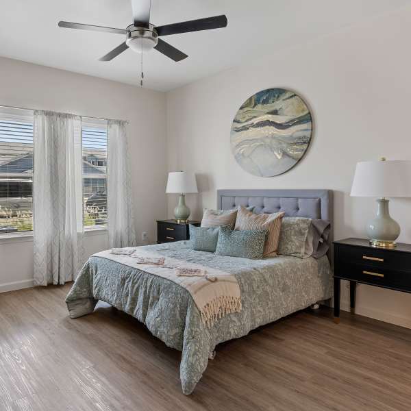 Modern vibrant bedroom with wooden flooring at Parc at Ingleside in Ingleside, Texas