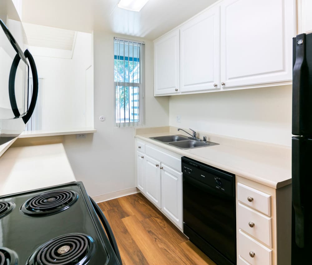 Fully equipped kitchen and black appliances at Bidwell Park Fremont in Fremont, California