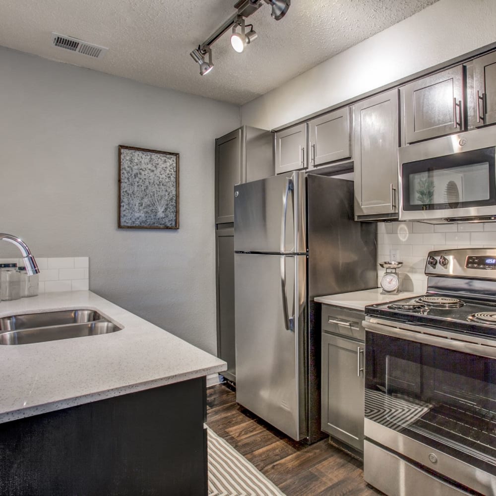 Resident living space that includes a ceiling fan at The Reese at Eastchase in Fort Worth, Texas