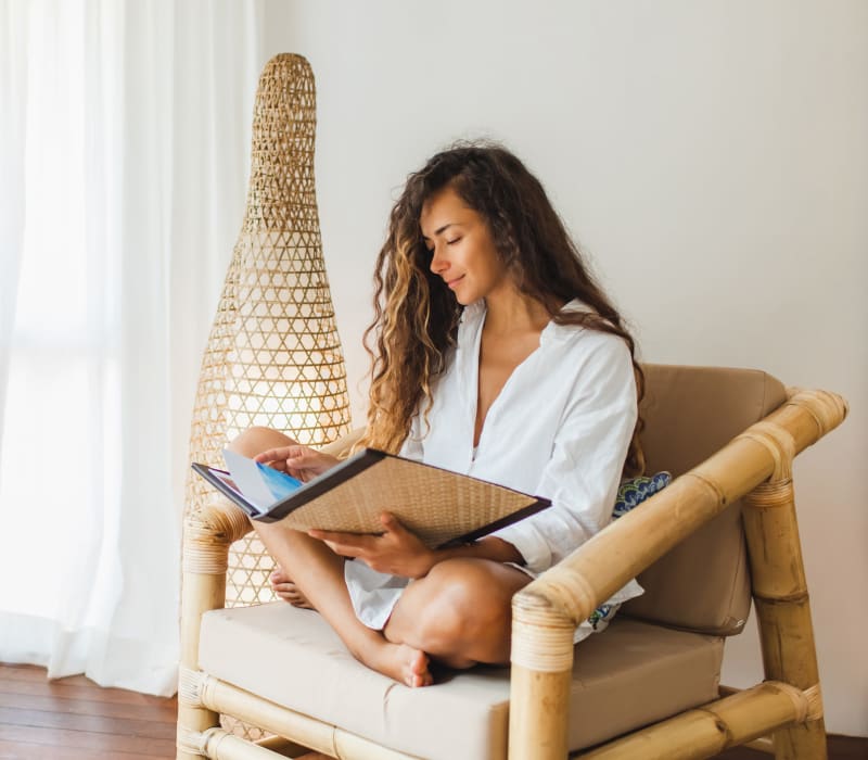 Woman reading a book at Arthaus Apartments in Allston, Massachusetts
