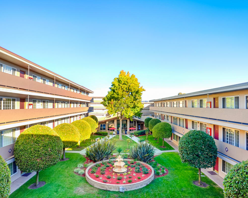 Manicured courtyard at St. Moritz Garden Apartments in San Leandro, California