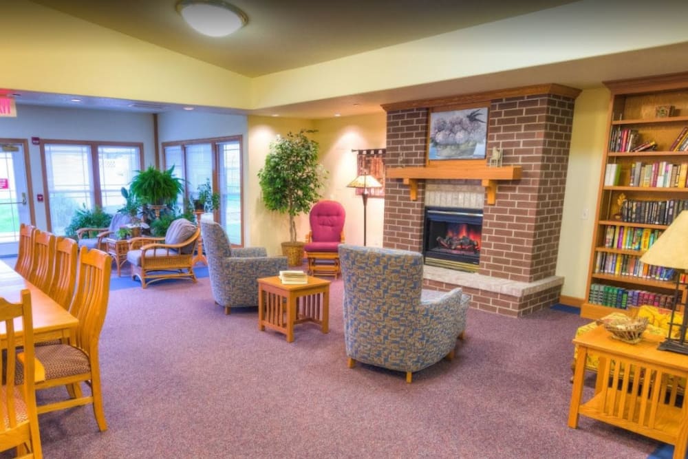Common area with plenty of seating and a fire place at Addington Place of Ottumwa in Ottumwa, Iowa