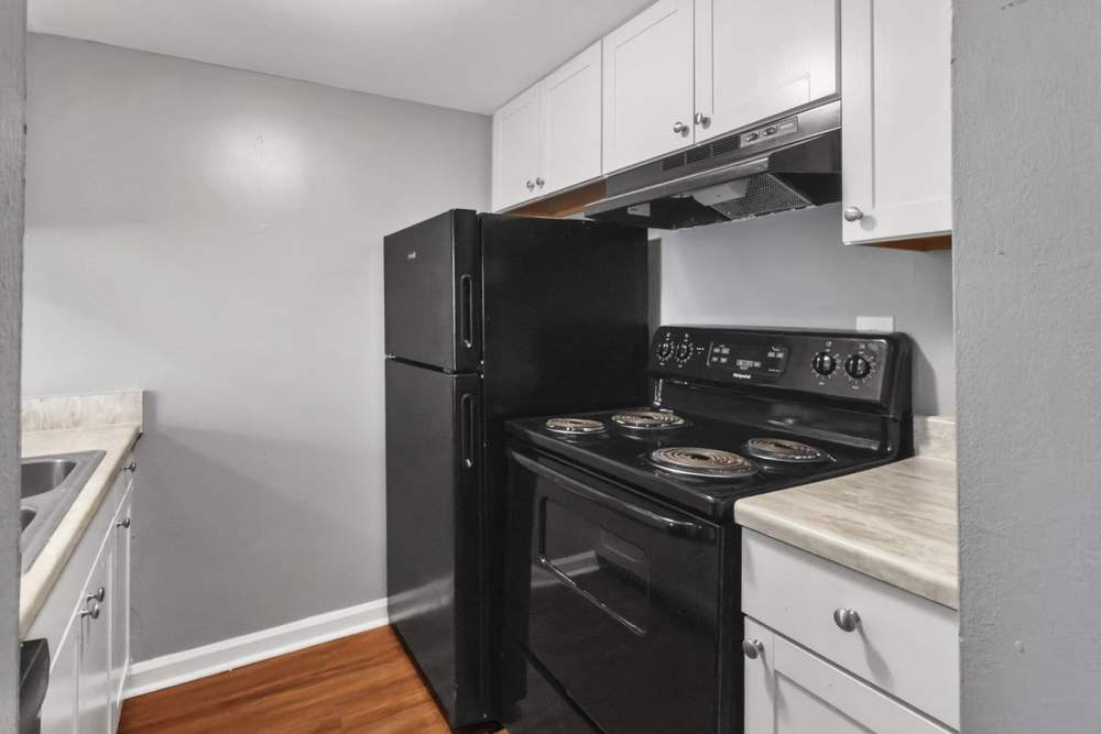 Kitchen with black appliances at Amelia Apartments and Townhomes in Valdosta, Georgia