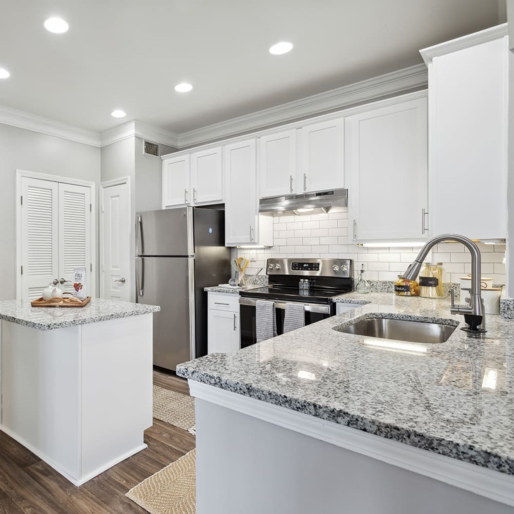 Gourmet kitchen with white cabinetry and subway tile backsplash at Five Oaks in Tucker, Georgia