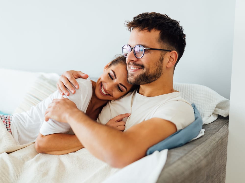 Couple relaxing on the couch together at The Collection Townhomes in Dallas, Texas