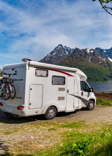 An RV at a high mountain lake, that normally stays at Storage World