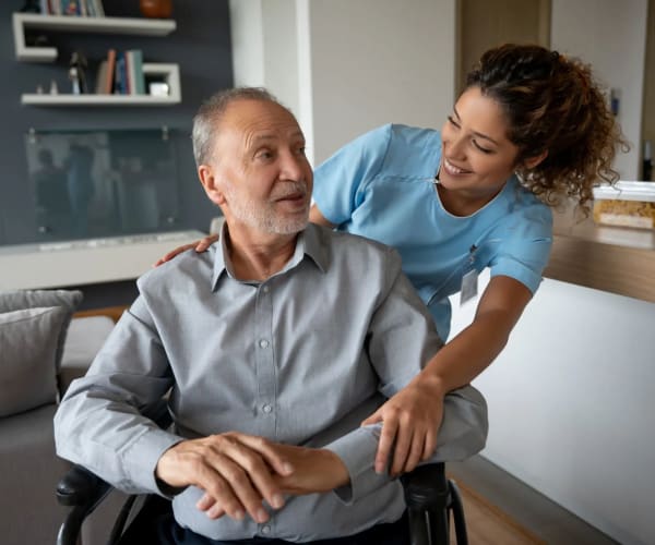 Caregiver assisting a resident at Pacifica Senior Living McMinnville in McMinnville, Oregon