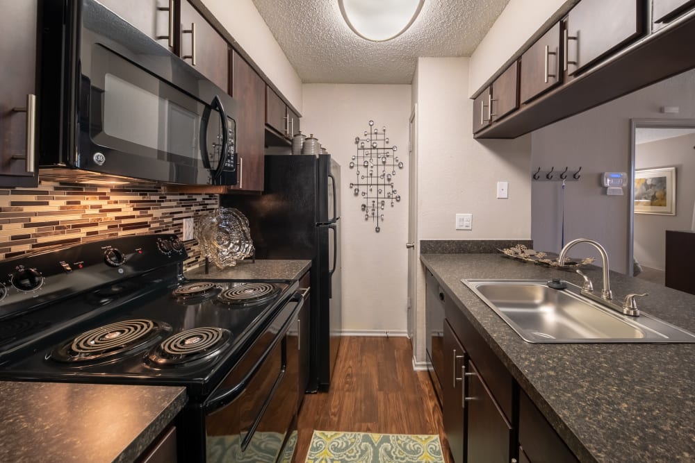 Modern kitchen with beautiful wood cabinets at Trails of Towne Lake in Irving, Texas