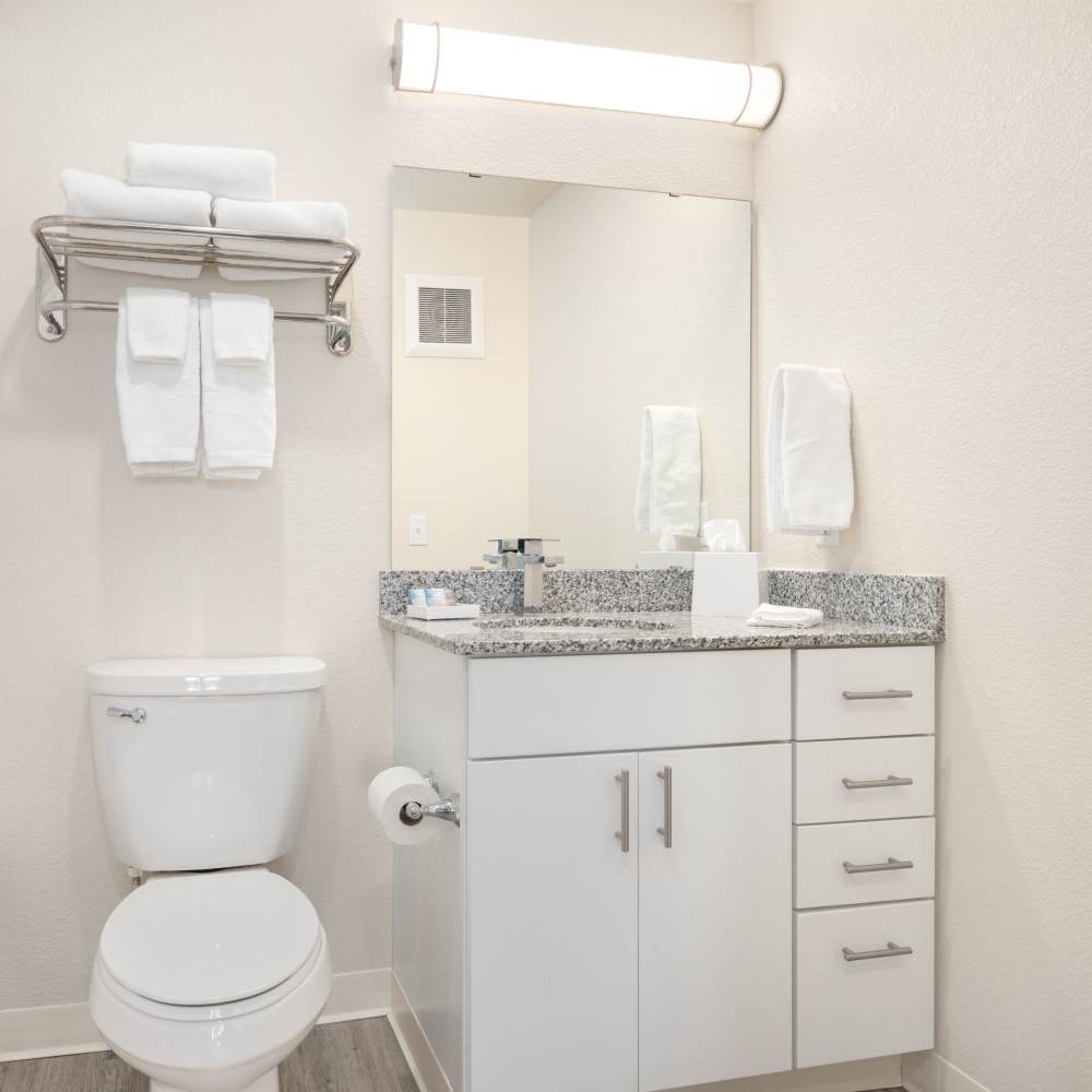 Bathroom with a large mirror at WaterWalk Minneapolis - Plymouth in Plymouth, Minnesota