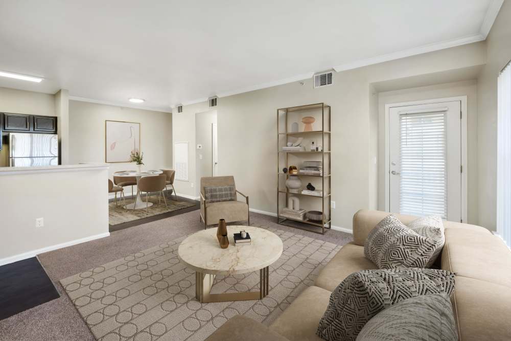 Living room with access to private patio at Westridge Apartments in Aurora, Colorado