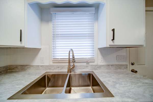 Dishwasher with white cabinets at The Manor Townhomes in Winston-Salem, North Carolina
