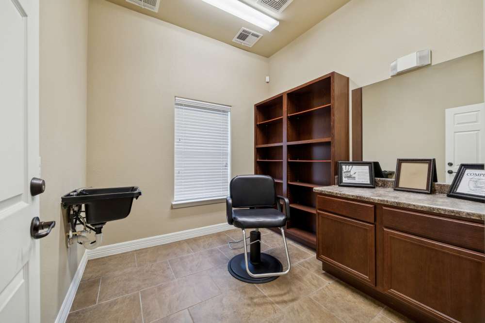 Stylish salon space featuring modern cabinetry and ample natural light at Arbor Pines in Orange, Texas 