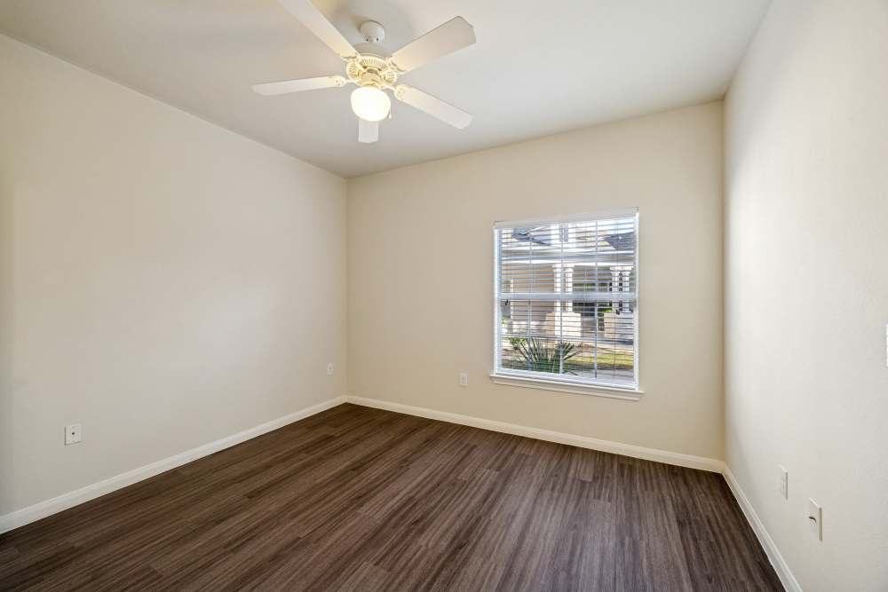 Charming bedroom with natural light and modern finishes at Arbor Pines in Orange, Texas.
