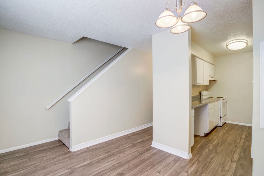 Two-story home with hardwood style flooring at Riverstone Apartments in Bryan, Texas