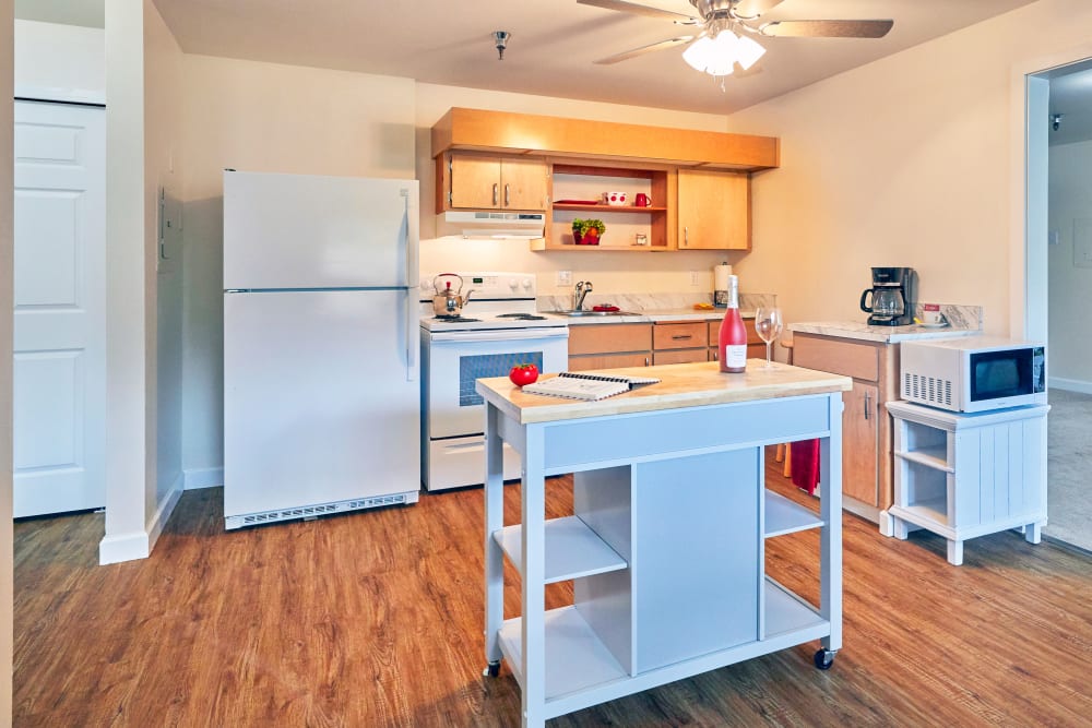 Brightly lit kitchen in senior living apartment in Shorewood Senior Living in Florence, Oregon