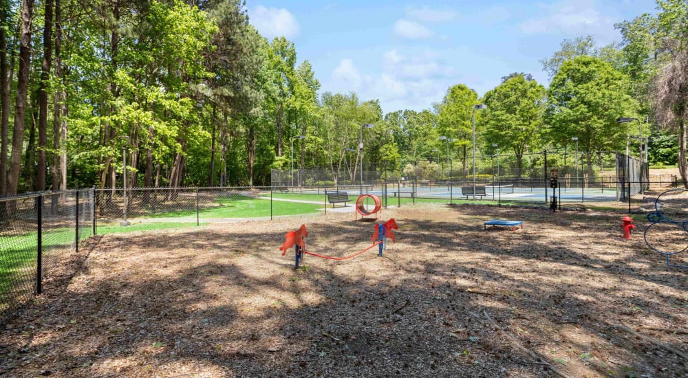 Fenced dog park with agility equipment at Hawthorne Gates in Atlanta, Georgia