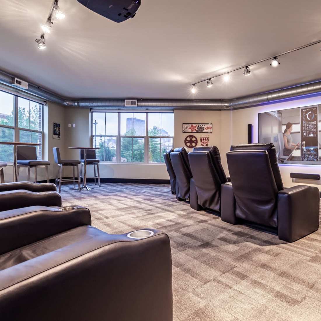 Cozy lounge area with leather recliners and large windows for natural light at Water Street Apartments in Dayton, Ohio