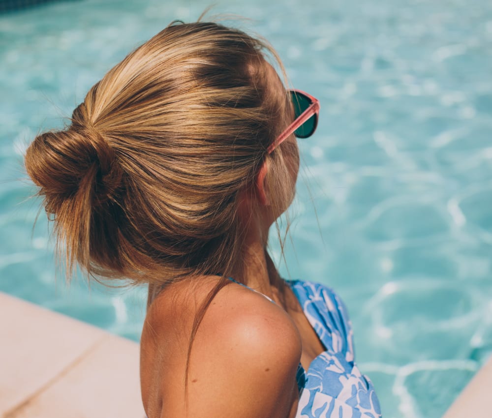 Resident relaxing at the swimming pool at The Columns at Lake Ridge in Dunwoody, Georgia