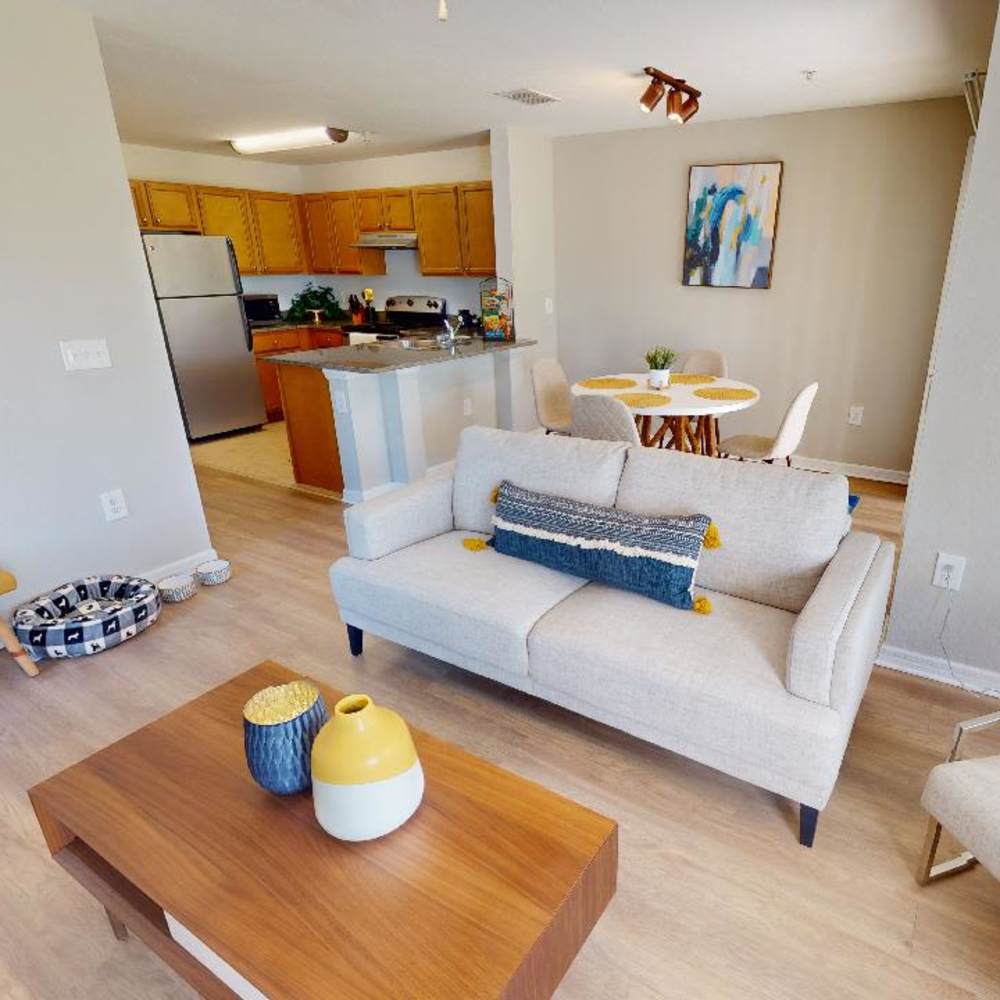 A living room with wood-style flooring at The Reserve at Brookhaven in Palm Coast, Florida