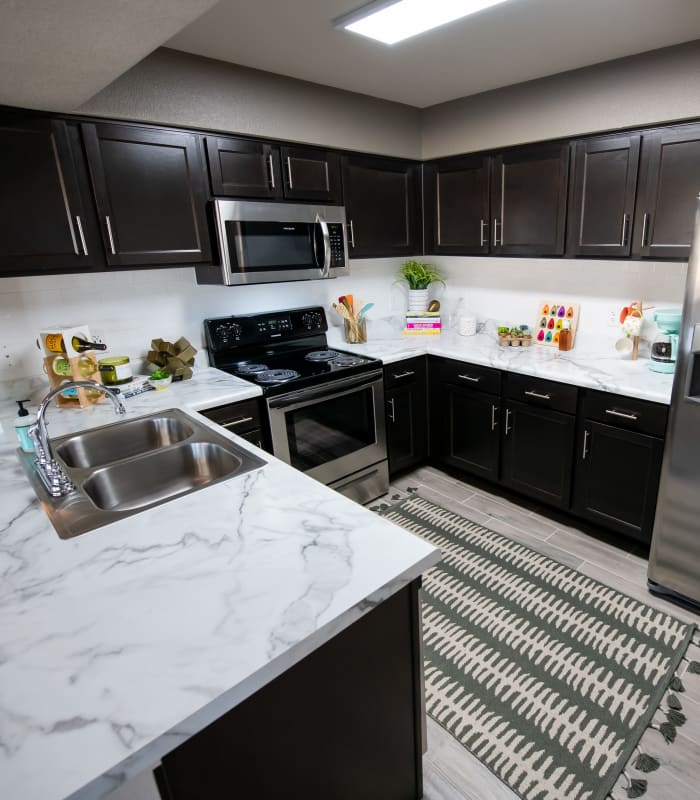 Kitchen with granite countertops at Portico at Friars Creek Apartments in Temple, Texas