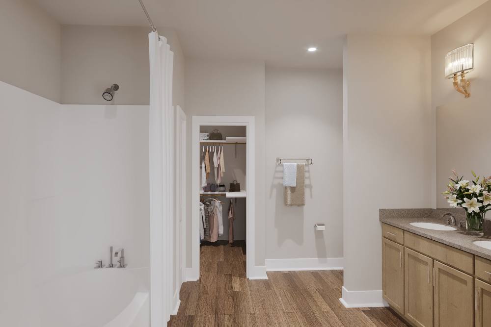 Bright bathroom with sink, bathtub and wood-style flooring Willow Brook Townhomes in Bossier City, Louisiana