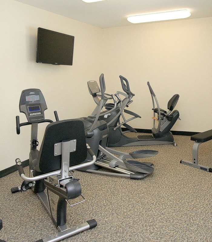 Resident working out in the gym at Legends at North Ponds in Webster, New York