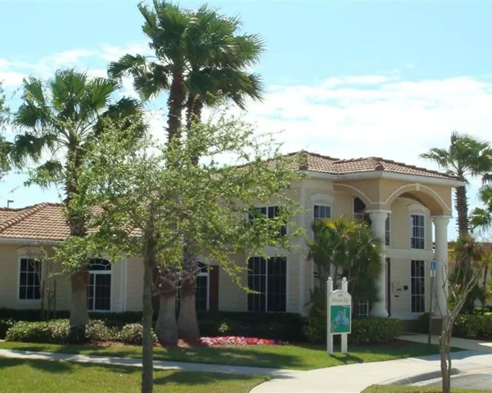 Exterior with welcome sign and palm trees at Mission Bay in Rockledge, Florida