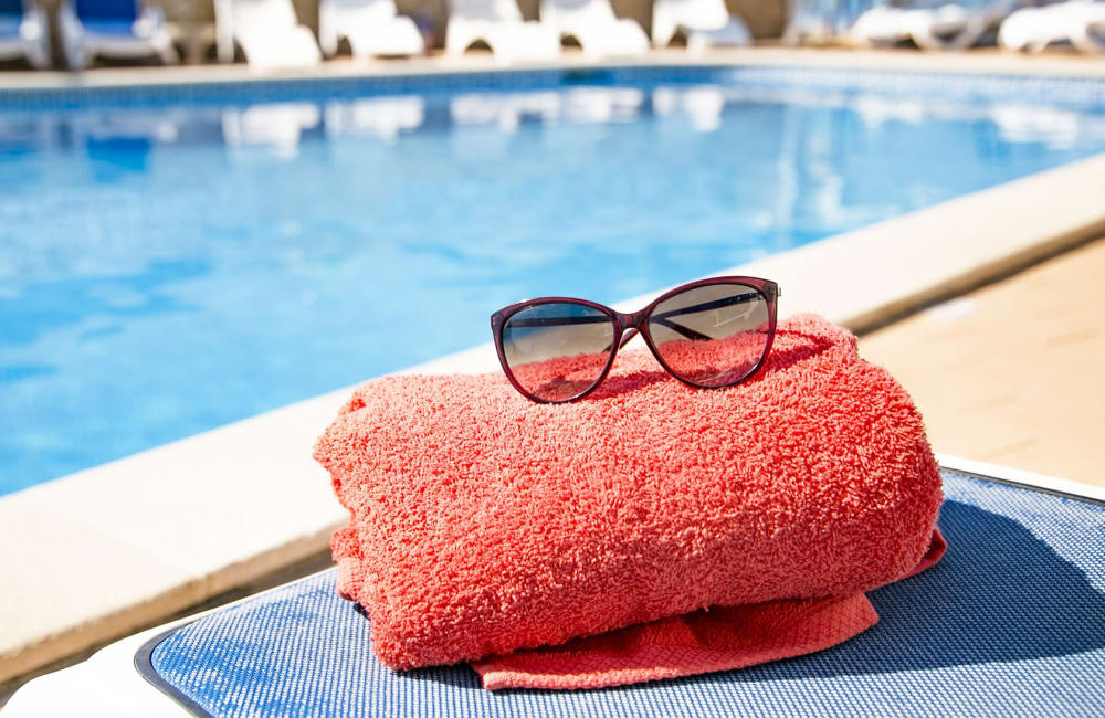 Sunglasses resting on a towel next to the pool at Canterbury Heights in Asheville, North Carolina