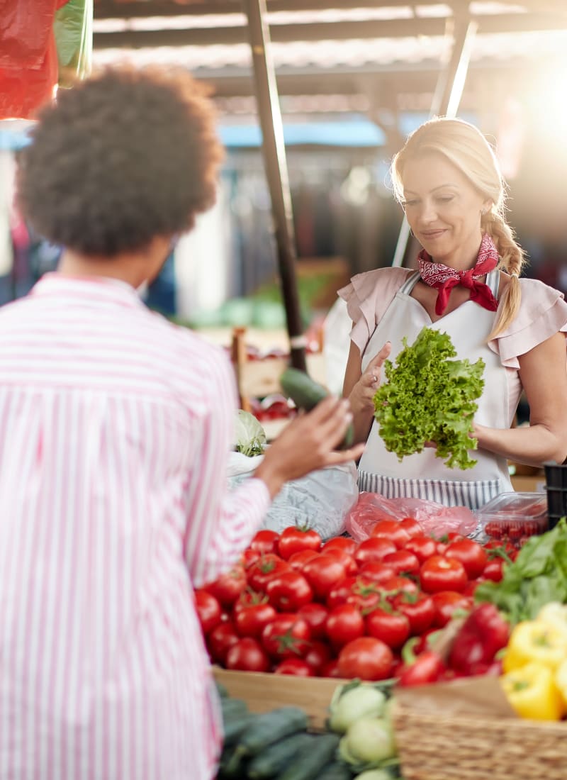 Resident shopping for produce near Marquis at Desert Ridge in Phoenix, Arizona